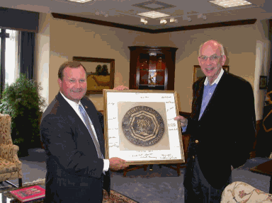 CFTC Chairman James E. Newsome presents Senator Robert F. Bennett, Chairman of the Appropriations Subcommittee on Agriculture, Rural Development, and Related Agencies, with a photograph of the brass CFTC seal