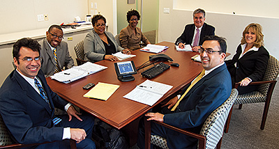 Photo showing Office of Data and Technology staff in a meeting. Photo by Clark Day Photography