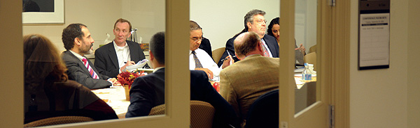 Photo showing the General Counsel heading a staff meeting.