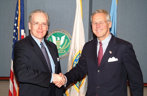 Commodity Futures Trading Commission (CFTC) Chairman Reuben Jeffery III (right) and Federal Energy Regulatory Commission (FERC) Chairman Joseph T. Kelliher shake hands after signing a Memorandum of Understanding regarding the sharing of energy trading information. The agreement fulfills a requirement of the Energy Policy Act of 2005.