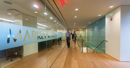 Photo showing Division of Market Oversight staff outside the Market Watch room. Photo by Clark Day Photography.