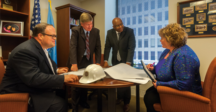 Photo showing Office of the Executive Director staff in a meeting. Photo by Clark Day Photography.