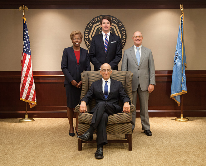 Photo showing the Fiscal Year 2014 Commissioners. Front row: Timothy G. Massad, Chairman.  Back row from left; Sharon Y. Bowen, Commissioner;  Mark P. Wetjen, Commissioner; J. Christopher Giancarlo, Commissioner.