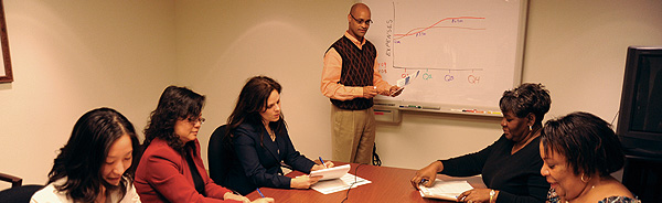 Photo showing accounting staff in a meeting.
