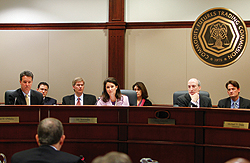 Photo showing Scott O'Malia and Jill Sommers, commissioners of the U.S. Commodity Futures Trading Commission, left, to right, and Gary Gensler, chairman of the U.S. Commodity Futures Trading Commission, listening to Don Heitman, special counsel of market oversight division with the CFTC, speak during a meeting at the CFTC in Washington, D.C., U.S., on Tuesday, Oct. 19, 2010. Photo by Andrew Harrer/Bloomberg via Getty Images.