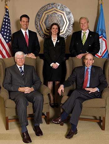 Photo showing the Fiscal Year 2011 commissioners. Back row from left; Scott D. O'Malia, Commissioner;  Jill E. Sommers, Commissioner; Bart Chilton, Commissioner. Front row from left; Michael V. Dunn, Commissioner; Gary Gensler, Chairman. Photo by Clark Day Photography.