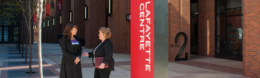 Photo showing Office of Executive Director staff in a discussion. Photo by Clark Day Photography.